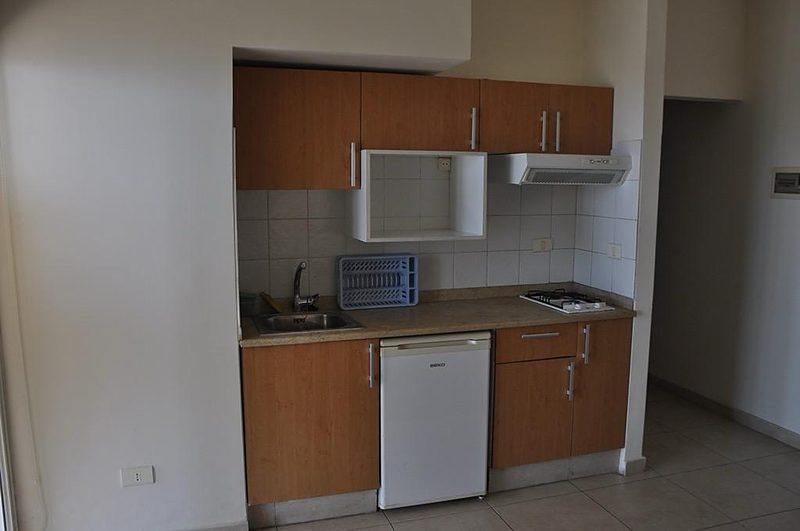 Kitchenette with sink, hob, fridge and generous counter space